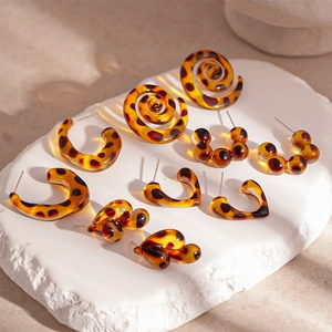 Vintage leopard resin earring set featuring snail, heart, and C-shaped drop studs