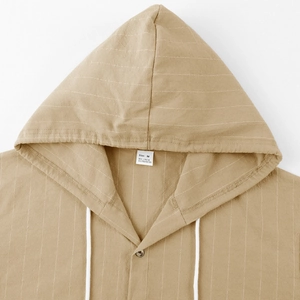 Detail view of khaki striped linen hoodie shirt collar showing fabric texture and drawstring