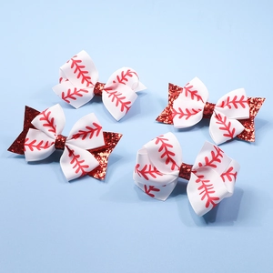 Detail of four baseball-themed ribbon hair bows with red glitter accents on light blue background