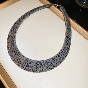 Detail of leopard print choker necklace with metallic leopard pattern and lobster clasp