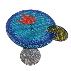 Detailed view of cocktail glass clutch bag with colorful crystals and lemon decoration