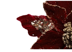 Gros plan du poinsettia de Noël en velours rouge avec paillettes et bords dorés
