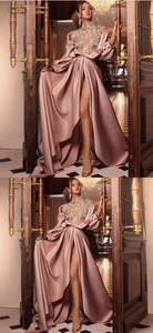 Macro view of crystal rhinestone details and satin Bishop sleeves on pink evening gown