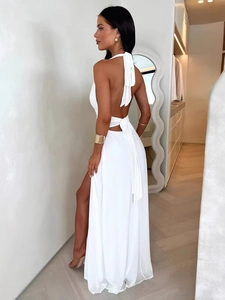 Elegant white backless halter maxi dress with high side slit for summer vacations