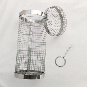 Detail of a rolling stainless steel BBQ grill basket with matching metal hook handle