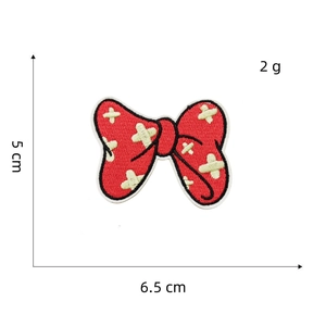 Detailed view of red embroidered bow patch with measurements 6.5 cm by 5 cm and 2g weight