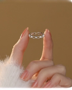 Detailed close-up of S925 sterling silver hollow heart ring with sparkling zircons