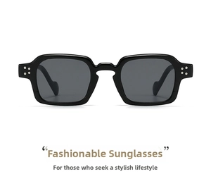 Detail of square black sunglasses with thick frames and silver rivet accents