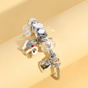 Silver twisted wire bracelet with sparkling elephant and heart charms and crystal beads