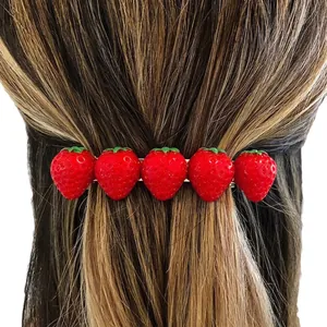 Handmade strawberry hair clips with five realistic red berries and green leaves