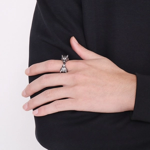 Detail of vintage wolf head titanium steel open ring on male hand for gothic street style