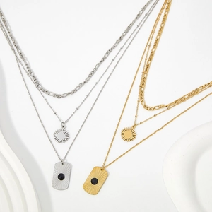 Layered gold and silver stainless steel necklaces with Figaro chain and black onyx pendant