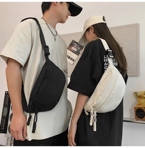 Detail of black and white versatile crossbody bags with woven rope zippers and wide straps