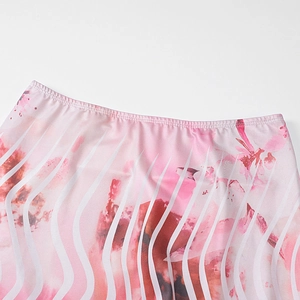 Detail of pink abstract floral print waist with pleated edges on lightweight fabric