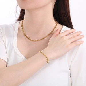 Detailed view of minimalist gold stainless steel O-link chain necklace and bracelet set