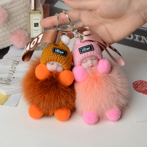 Cute fox fur ball doll keychains in pink and tan with knitted hats and satin ribbons