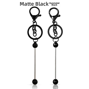 Detail of DIY beaded keychains in matte black and gunmetal finishes with lobster clasps