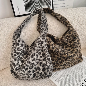 Detail of leopard print faux fur hobo tote bags in grey and brown for autumn winter style