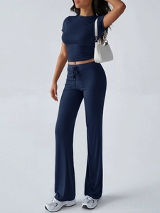 Detail of navy blue two-piece set featuring a cropped top and drawstring wide-leg pants