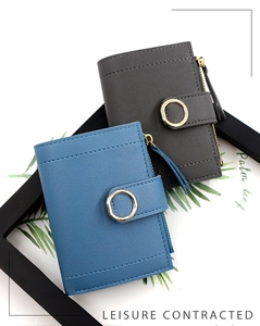 Detail of short leather wallets in blue and grey with gold round buckles and zippers