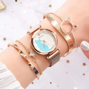 Detail shot of rose gold cat watch and matching bracelets set on a model wrist