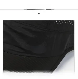 Detail view of black quick-dry sport cap featuring white side lettering and air vents