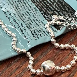 Close-up of a S925 sterling silver bead bracelet with a large polished center bead