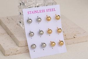 Detail view of 6 pairs of gold and silver stainless steel ball studs on display card
