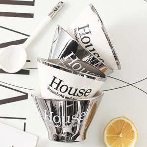 Modern conical ceramic and silver electroplated bowls stacked in minimalist Nordic style