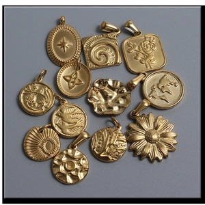 Detail view of 12 vintage gold cross and floral pendants for DIY jewelry making