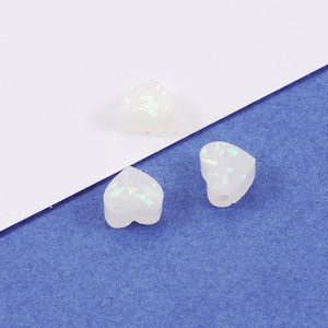 Three heart-shaped white synthetic opal beads with shimmer for DIY jewelry making