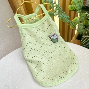 Detail of mint green breathable knit dog vest with wavy texture and cute cartoon patch