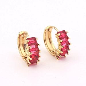 Detail of gold hoop earrings with rectangular red gemstones and hinged closure
