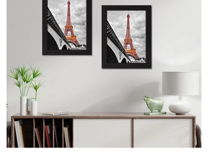 Modern black frame set featuring artistic Eiffel Tower print in a stylish living room