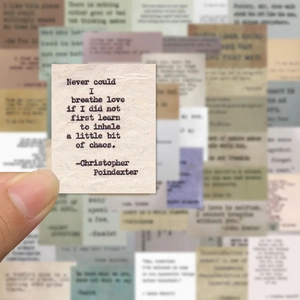 Close-up of vintage inspirational quote stickers with poetic text on aged paper