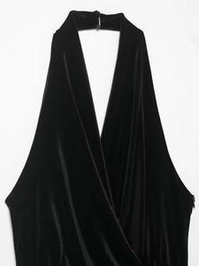 Detail of black velvet halter top showing plunging V-neckline and rich fabric texture
