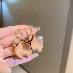 Detailed close-up of khaki petal earrings with gold crystal rings and elegant resin finish