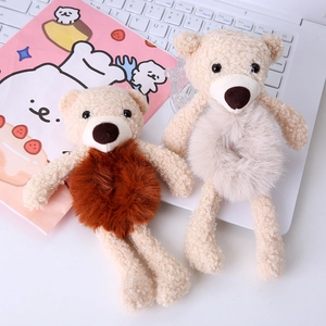 Close-up of cute plush bear hair ties in cream and brown teddy fleece material