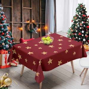 Detail of red Christmas tablecloth with yellow star patterns in a festive room
