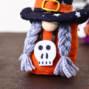 Detail of Halloween gnome with purple wizard hat and white skull pendant decoration