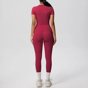 Rear view of tight-fitting deep red yoga set with short sleeve top and high waist pants