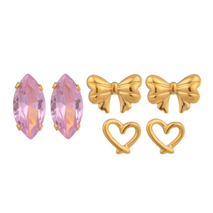 Detail of gold bow, pink marquise gem, and hollow heart stud earrings set for women