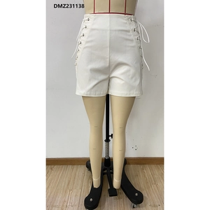 Detailed close-up of white high-waisted shorts featuring side lace-up metal eyelet design