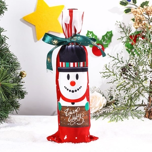 Detailed view of red Christmas wine bottle cover featuring snowman with Warm Wishes sign