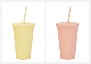 Detail view of 16oz frosted plastic tumblers in pale yellow and orange with straws