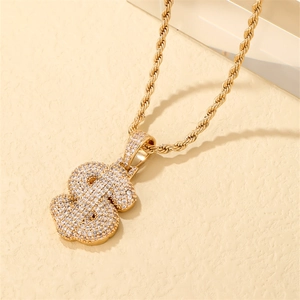 Gold-plated dollar sign pendant necklace with zircon micro-paving on a rope chain