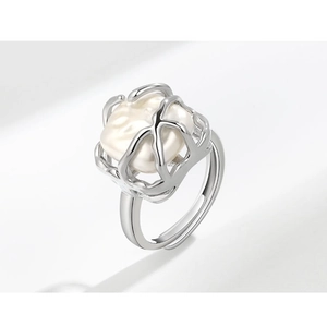 Detailed macro view of the adjustable silver ring with a baroque pearl in metal cage