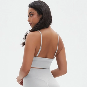 Detail of seamless grey sports bra with adjustable thin straps and high-waist yoga leggings