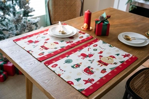Close-up of festive jacquard placemats with Santa and reindeer on a wooden table