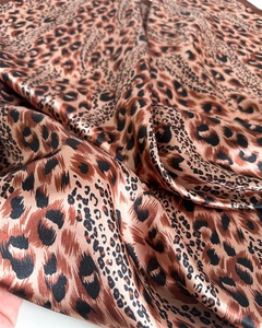 Detailed close-up of brown leopard print satin scarf fabric with silky glossy texture